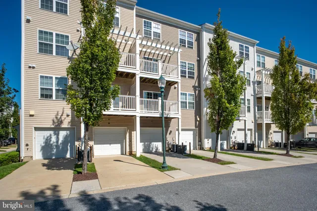 a front view of a building with a garden