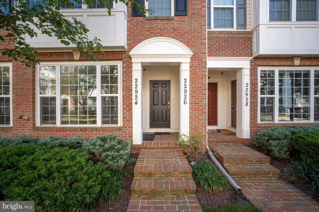 front view of a brick house with a large windows