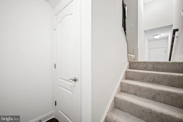 a view of staircase with white walls