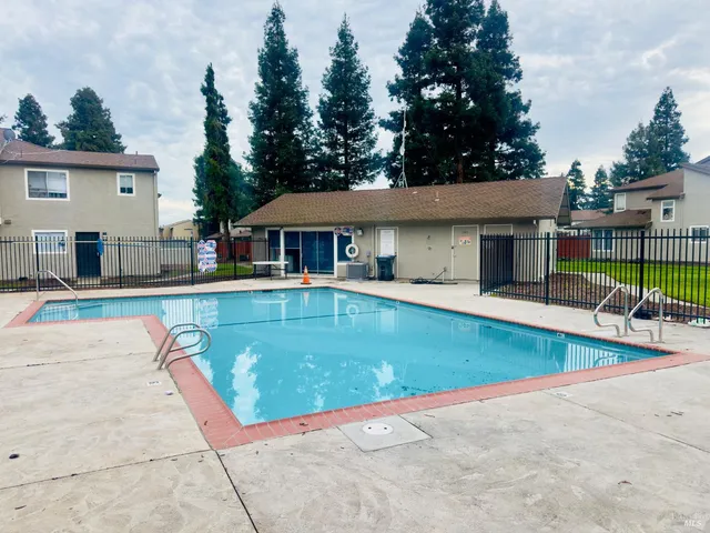 a view of a patio with swimming pool table and chairs