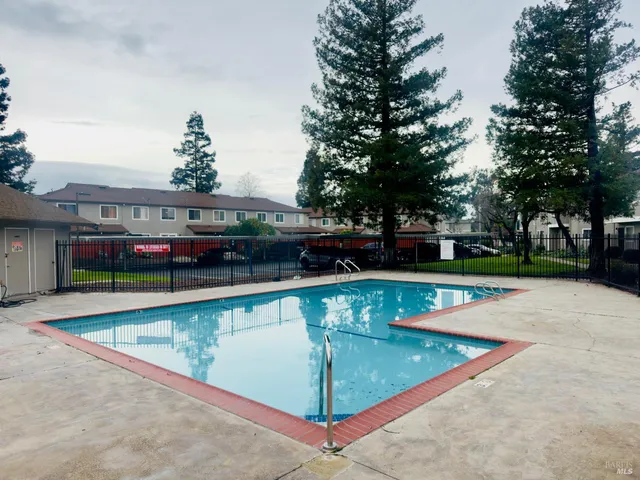 a view of a swimming pool with a yard