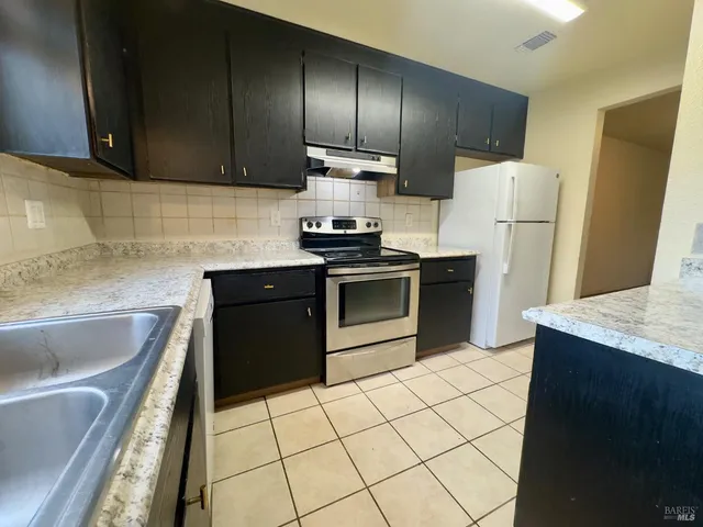 a kitchen with a sink stove and refrigerator