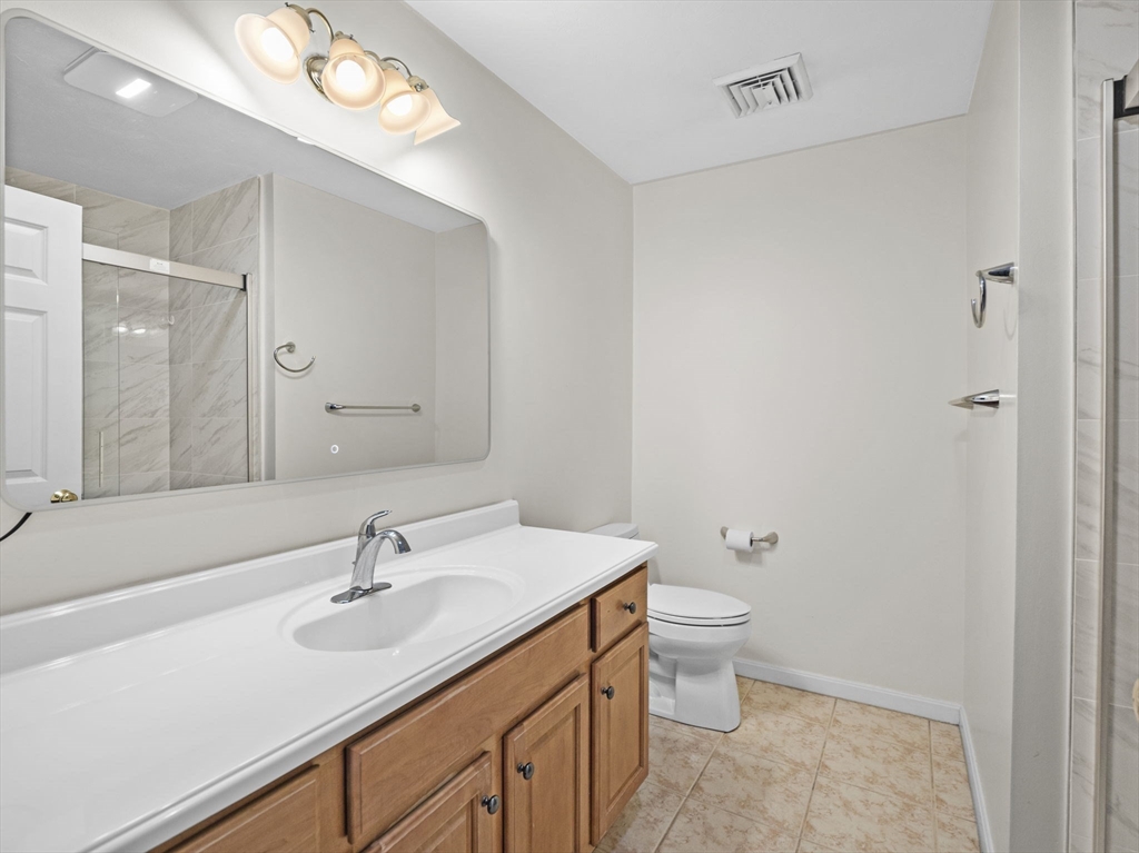 36 Knowlton Circle, Unit 36 Upton, MA 01568 - Photo 26 of 39 a bathroom with a sink a toilet a shower and a mirror