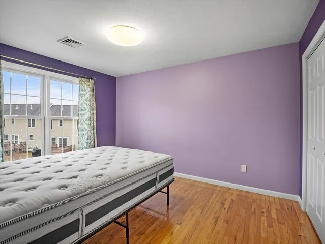 a bed sitting in a bedroom next to a window