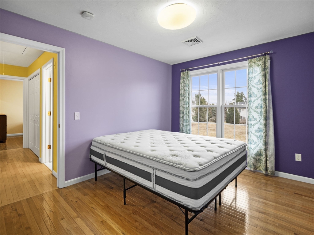 36 Knowlton Circle, Unit 36 Upton, MA 01568 - Photo 31 of 39 a bed sitting in a bedroom next to a window