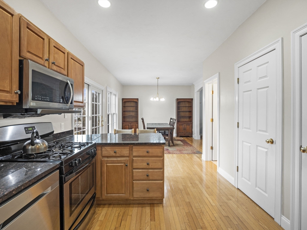 36 Knowlton Circle, Unit 36 Upton, MA 01568 - Photo 8 of 39 a kitchen with stainless steel appliances granite countertop a stove and a wooden floors