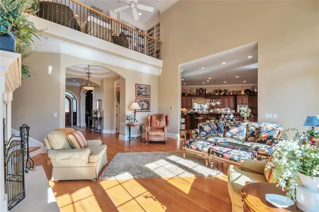 a dining room with furniture a chandelier and wooden floor