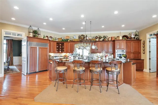 a kitchen with a stove and a wooden floor