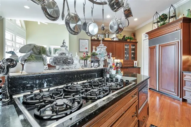a kitchen with stainless steel appliances granite countertop a sink and cabinets