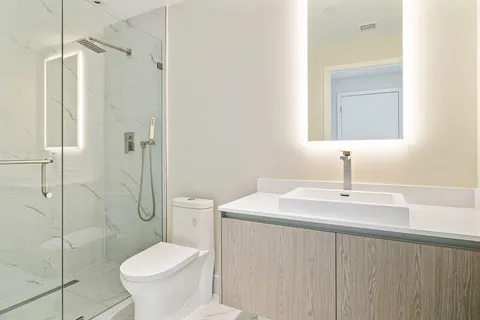 a bathroom with a sink toilet and shower