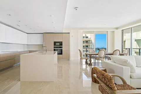 a living room with furniture a dining table and a fireplace