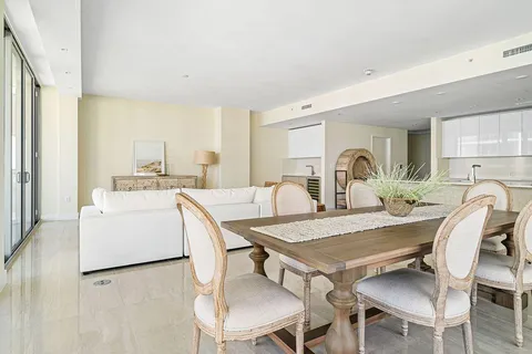 a view of a dining room with furniture and a large window