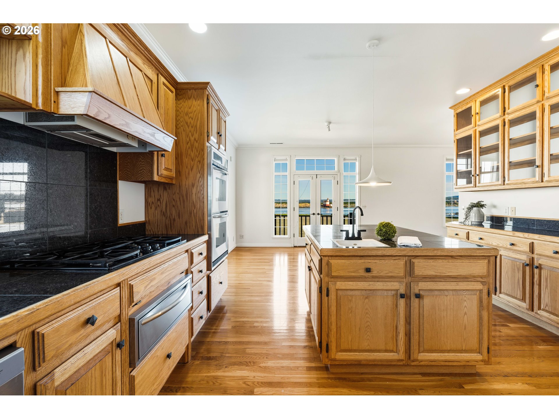 323 Madison Avenue Bandon, OR 97411 - Photo 18 of 43 a kitchen with stainless steel appliances granite countertop a sink and cabinets