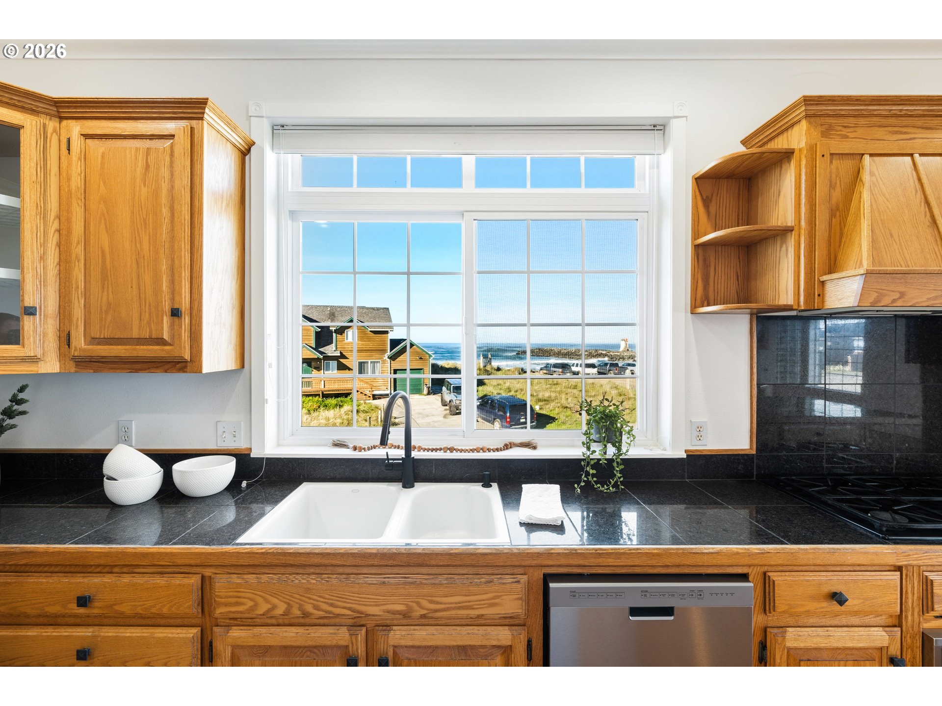 323 Madison Avenue Bandon, OR 97411 - Photo 20 of 43 a view of kitchen with a sink wooden cabinets and chair