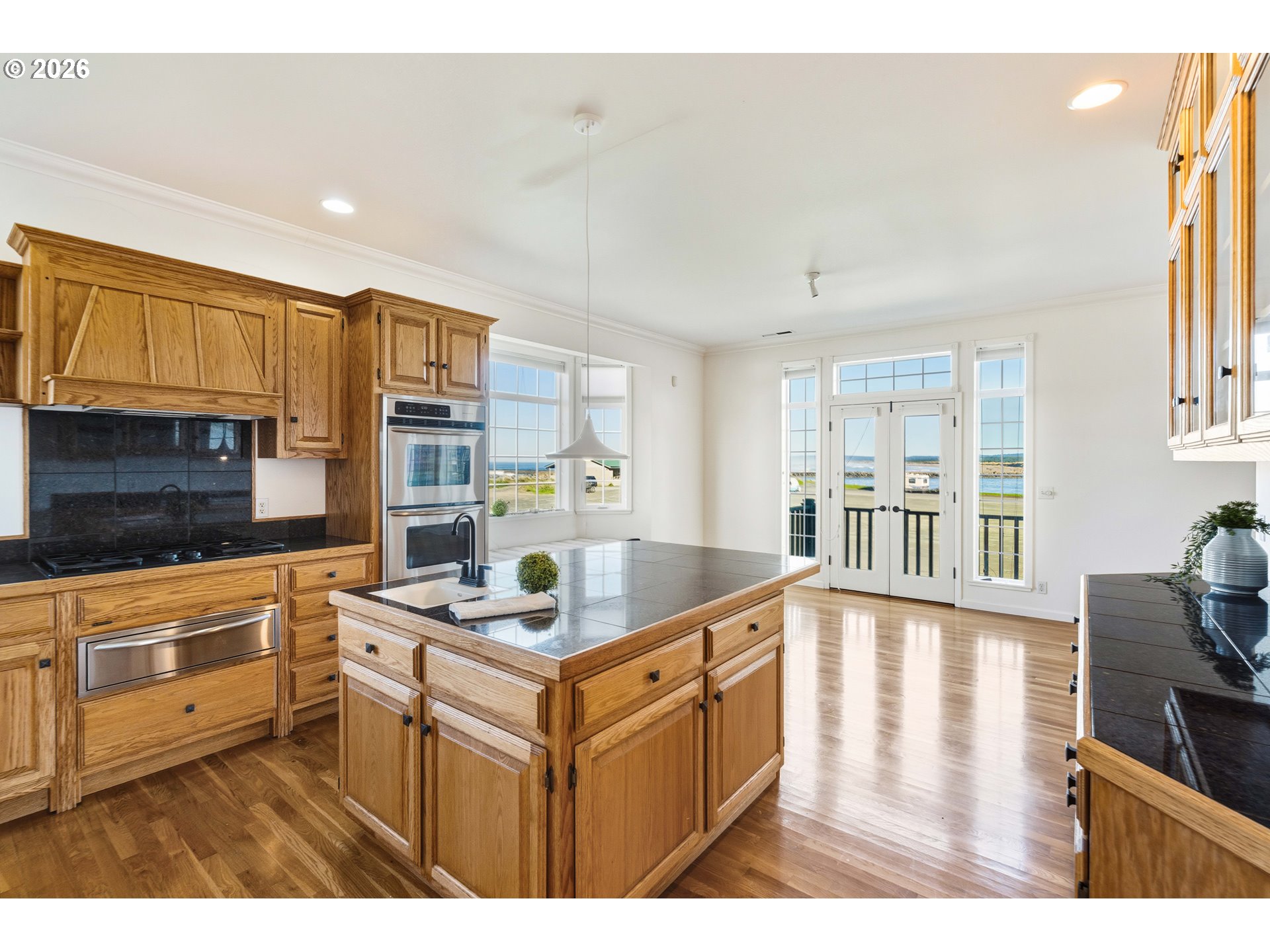 323 Madison Avenue Bandon, OR 97411 - Photo 22 of 43 a kitchen that has a lot of cabinets in it and appliances