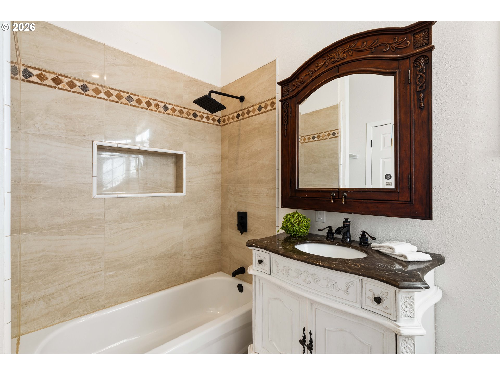 323 Madison Avenue Bandon, OR 97411 - Photo 27 of 43 a bathroom with a sink a bathtub and a mirror