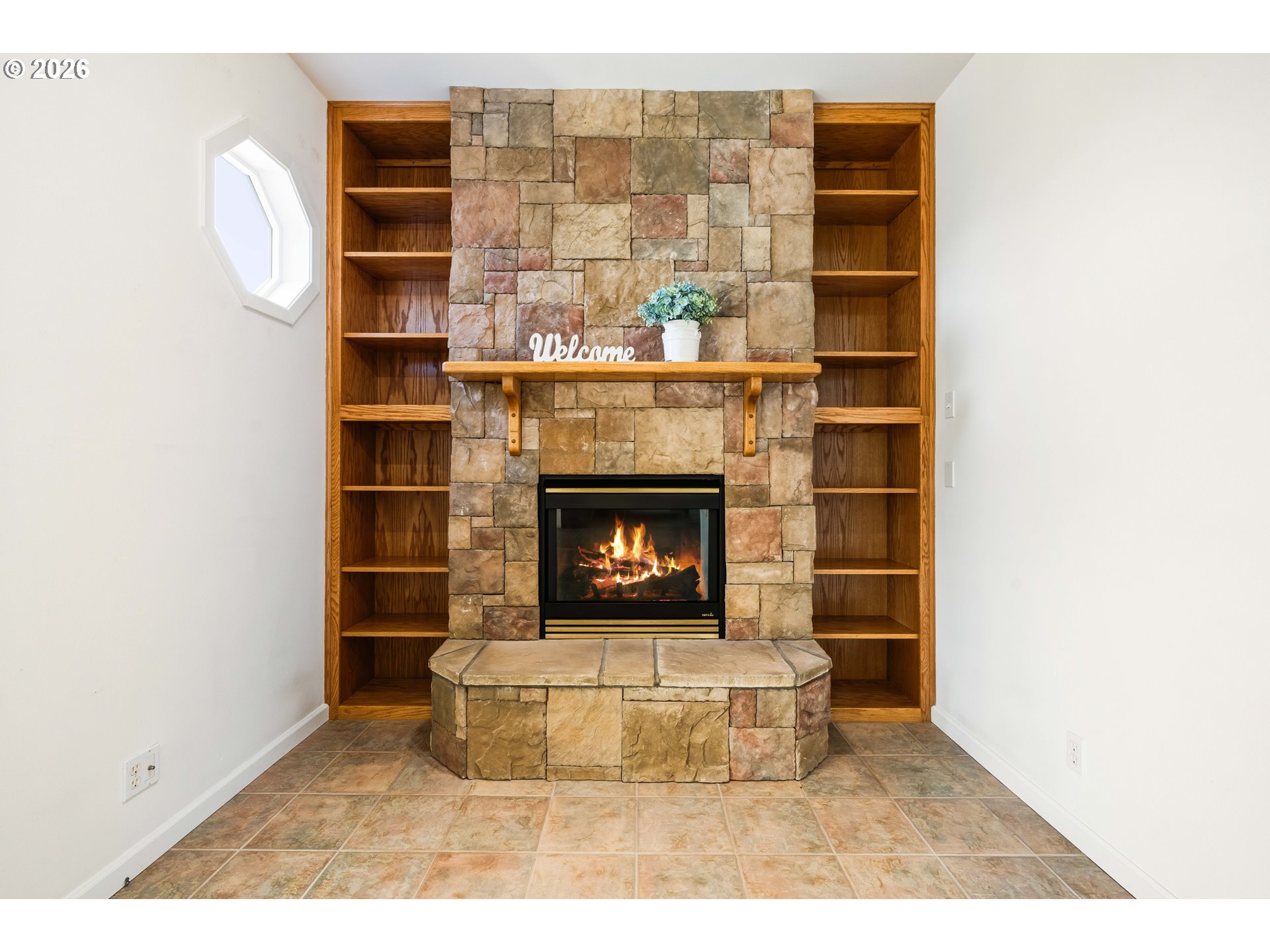 323 Madison Avenue Bandon, OR 97411 - Photo 38 of 43 a living room with a fireplace and a table