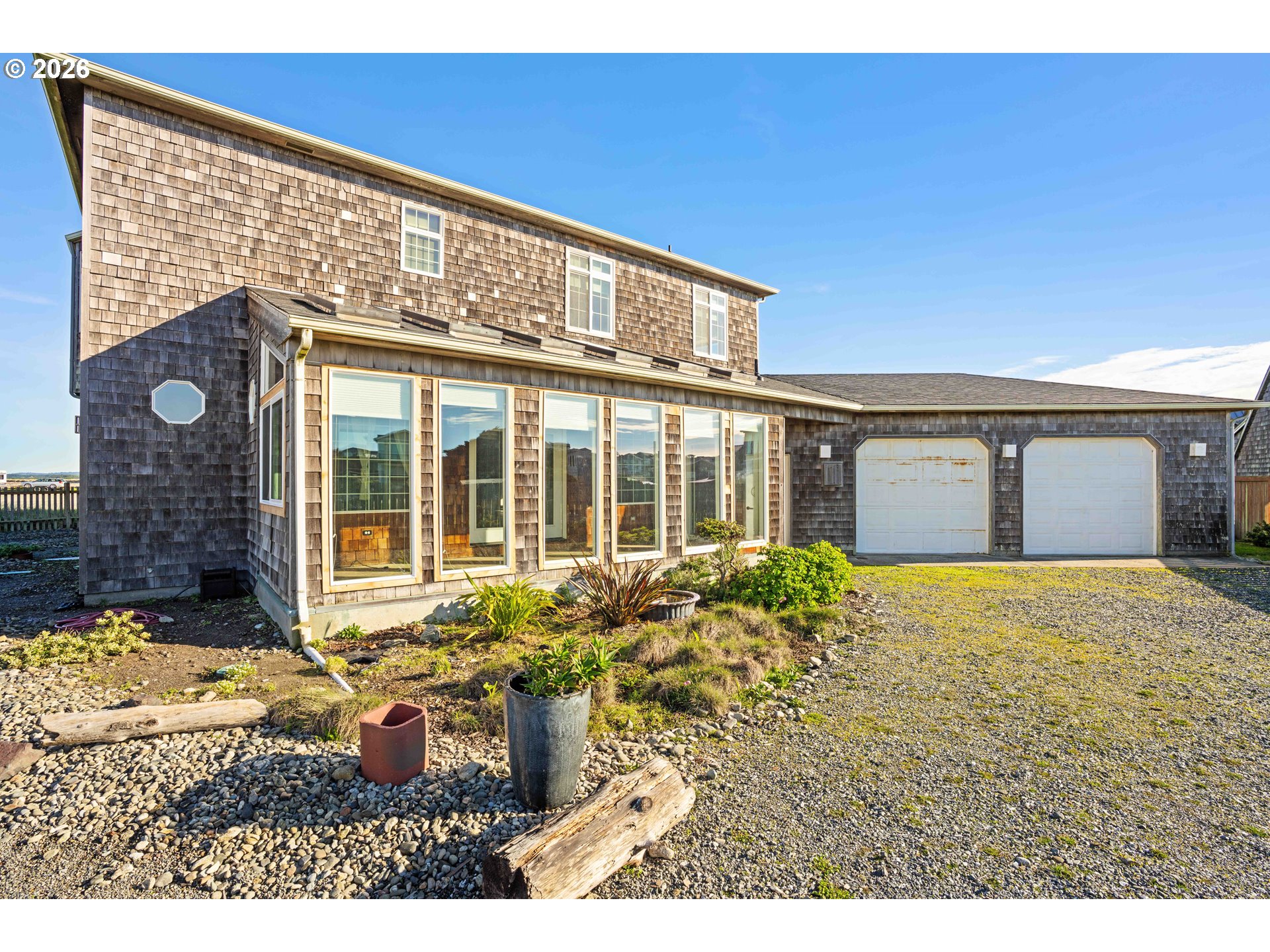 323 Madison Avenue Bandon, OR 97411 - Photo 7 of 43 a front view of a house with a yard