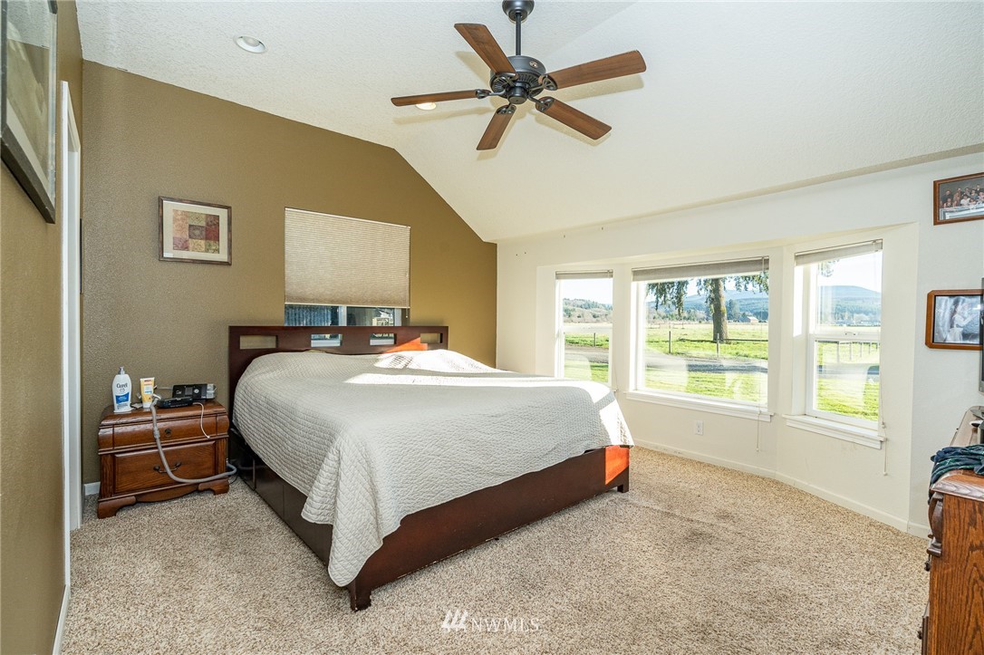 103 Mauerman Road Chehalis, WA 98532 - Photo 8 of 40 a spacious bedroom with a bed and a chandelier