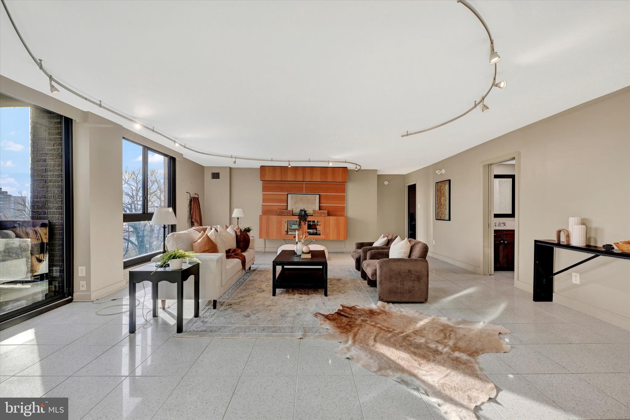 4100 North Charles Street, Unit 609 Baltimore, MD 21218 - Photo 11 of 36 a living room with furniture and a flat screen tv