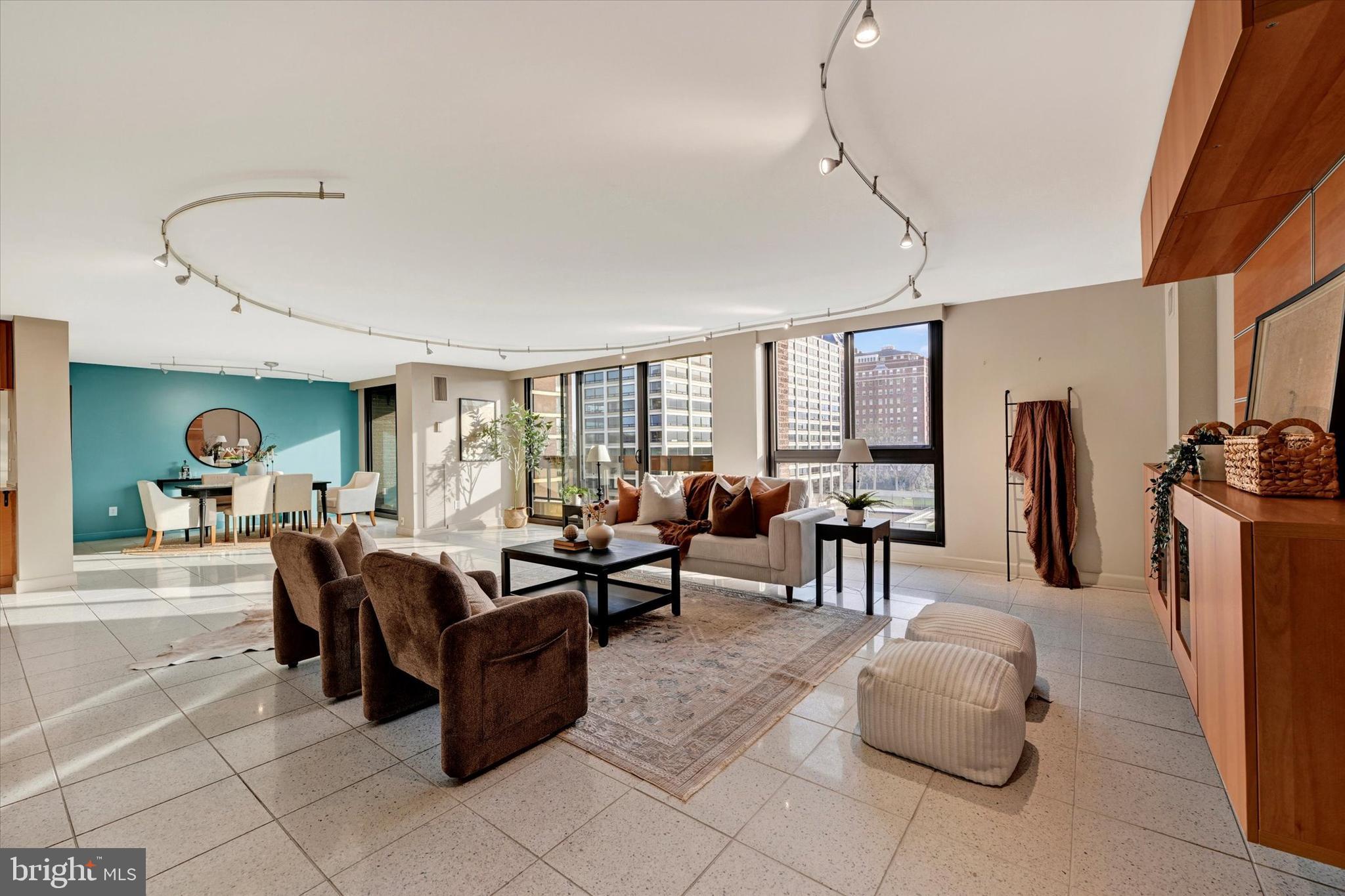 4100 North Charles Street, Unit 609 Baltimore, MD 21218 - Photo 13 of 36 a living room with furniture a dining table and a large window