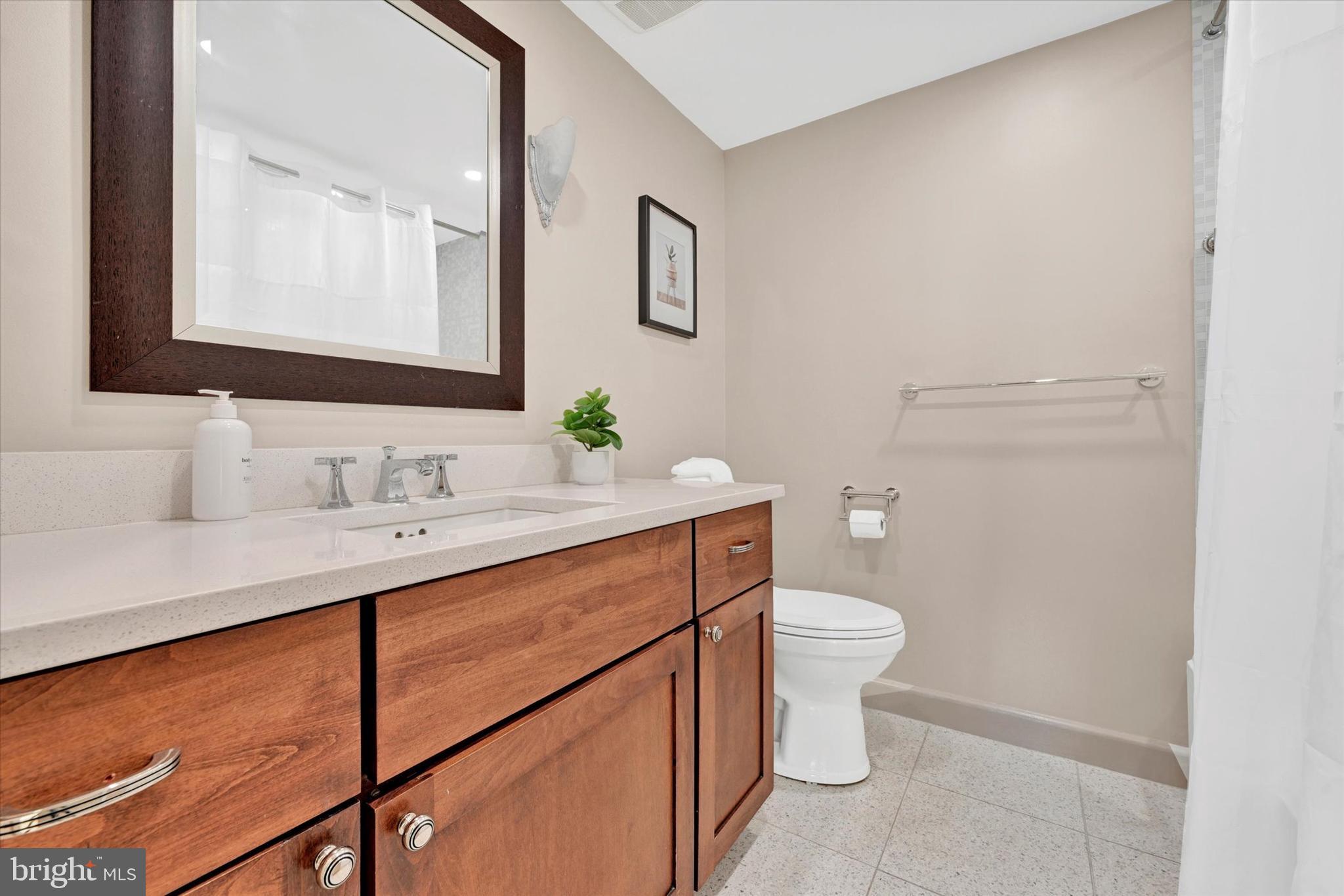 4100 North Charles Street, Unit 609 Baltimore, MD 21218 - Photo 15 of 36 a bathroom with a sink vanity mirror and toilet