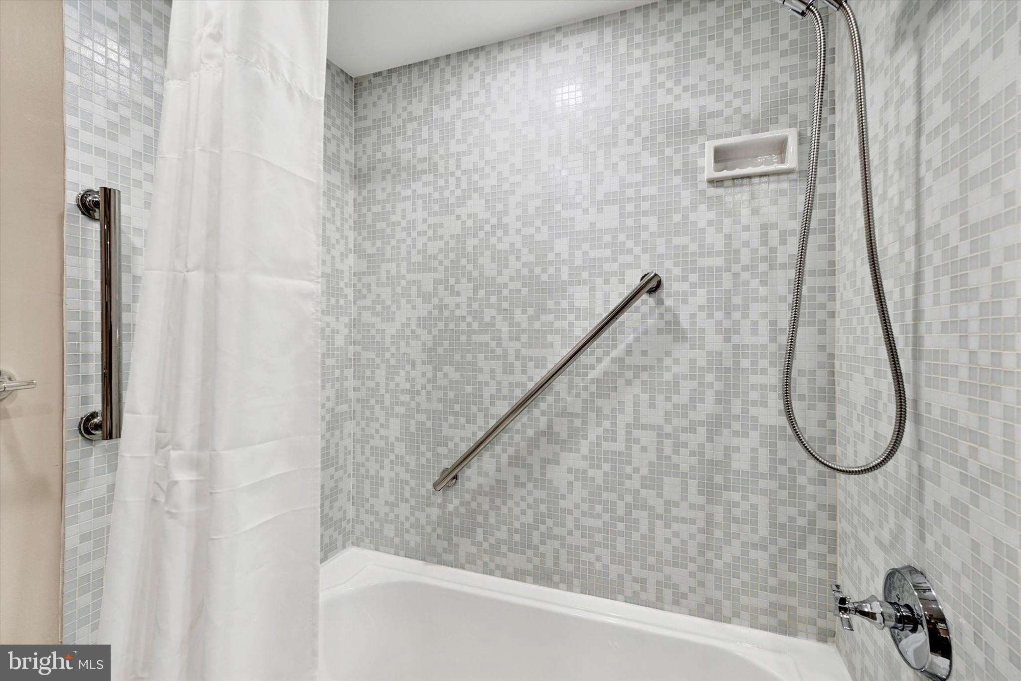 4100 North Charles Street, Unit 609 Baltimore, MD 21218 - Photo 16 of 36 a bathroom with a shower and a sink