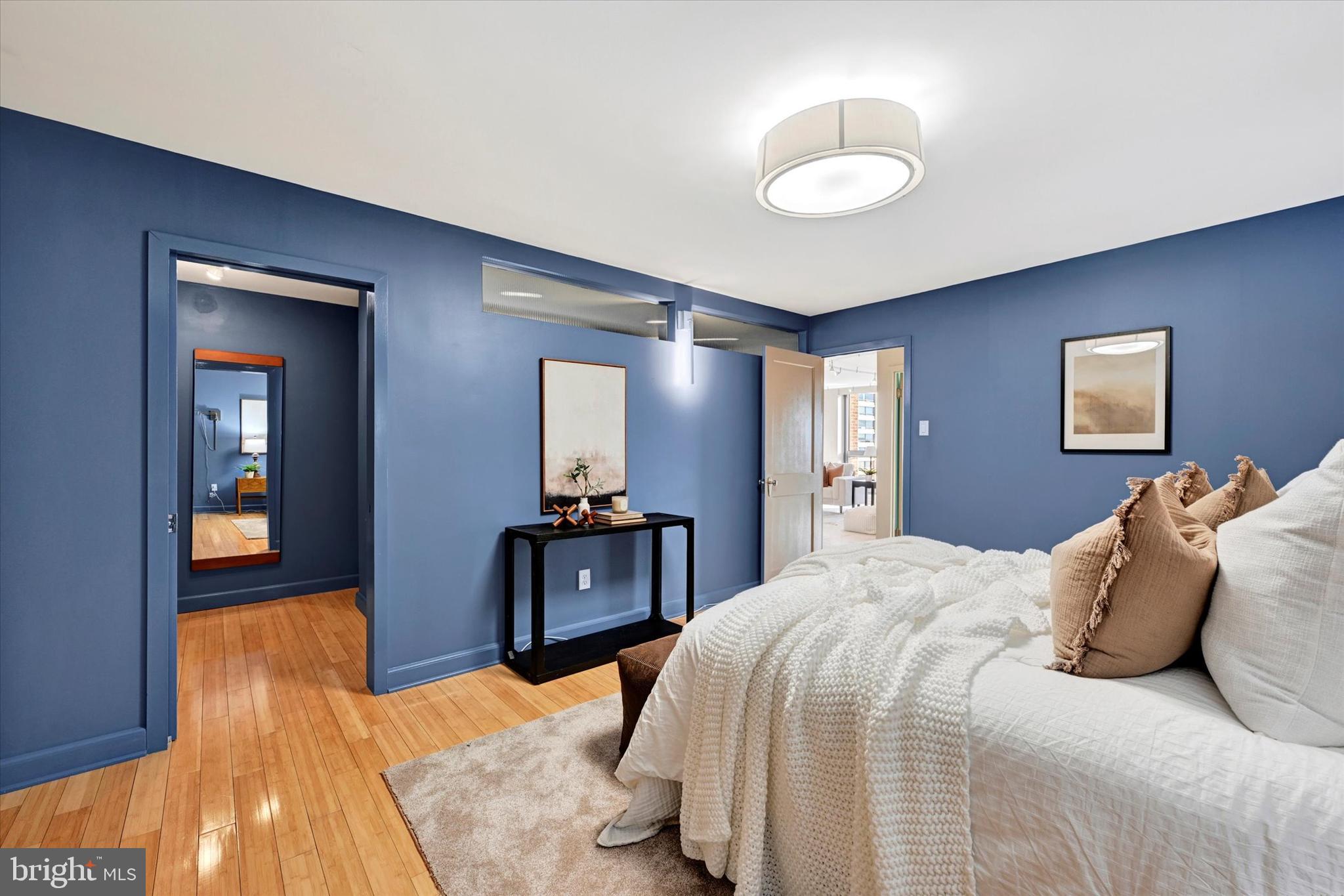 4100 North Charles Street, Unit 609 Baltimore, MD 21218 - Photo 20 of 36 a bedroom with a bed and a chandelier