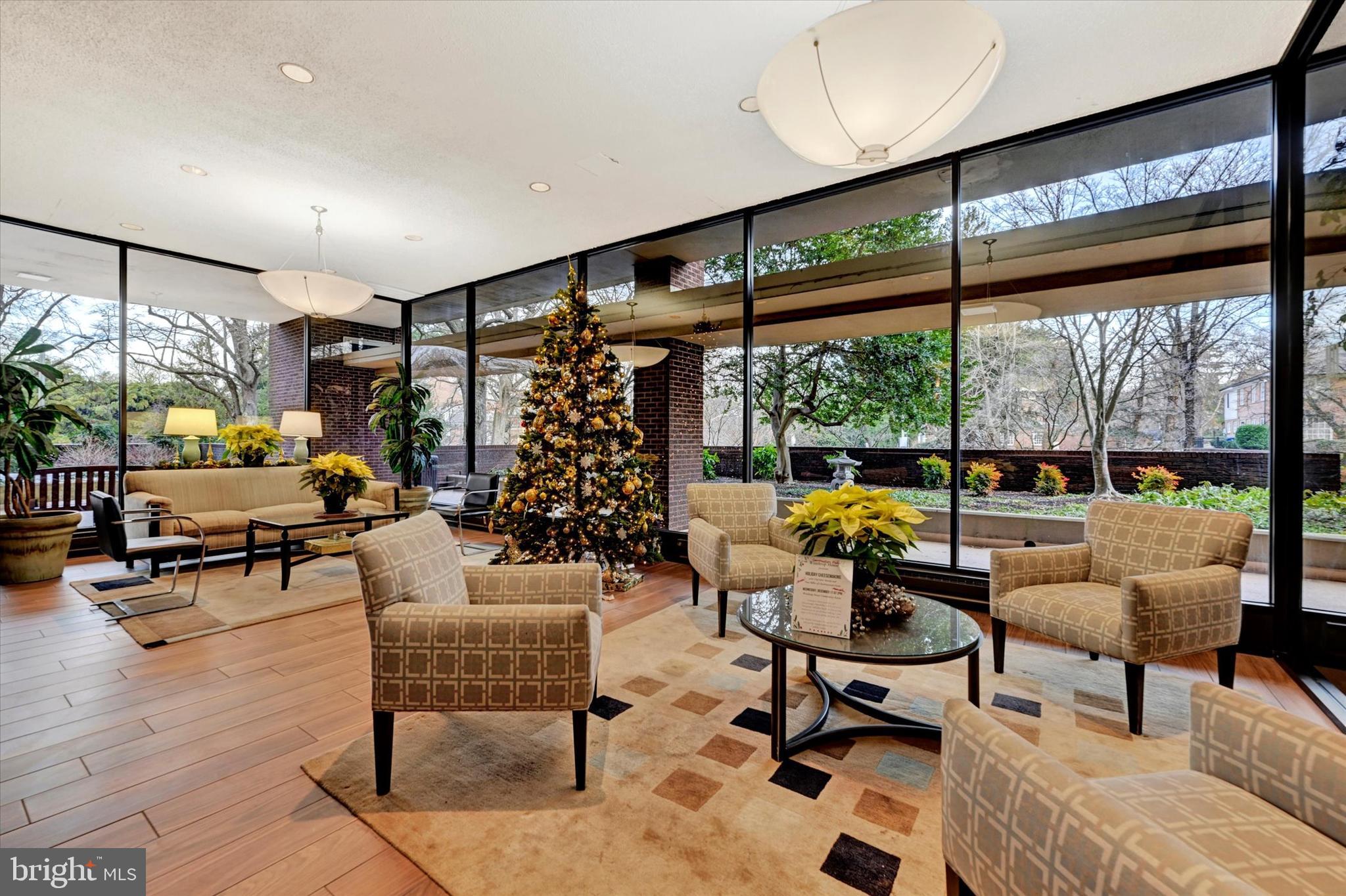 4100 North Charles Street, Unit 609 Baltimore, MD 21218 - Photo 29 of 36 a living room with patio furniture and a floor to ceiling window