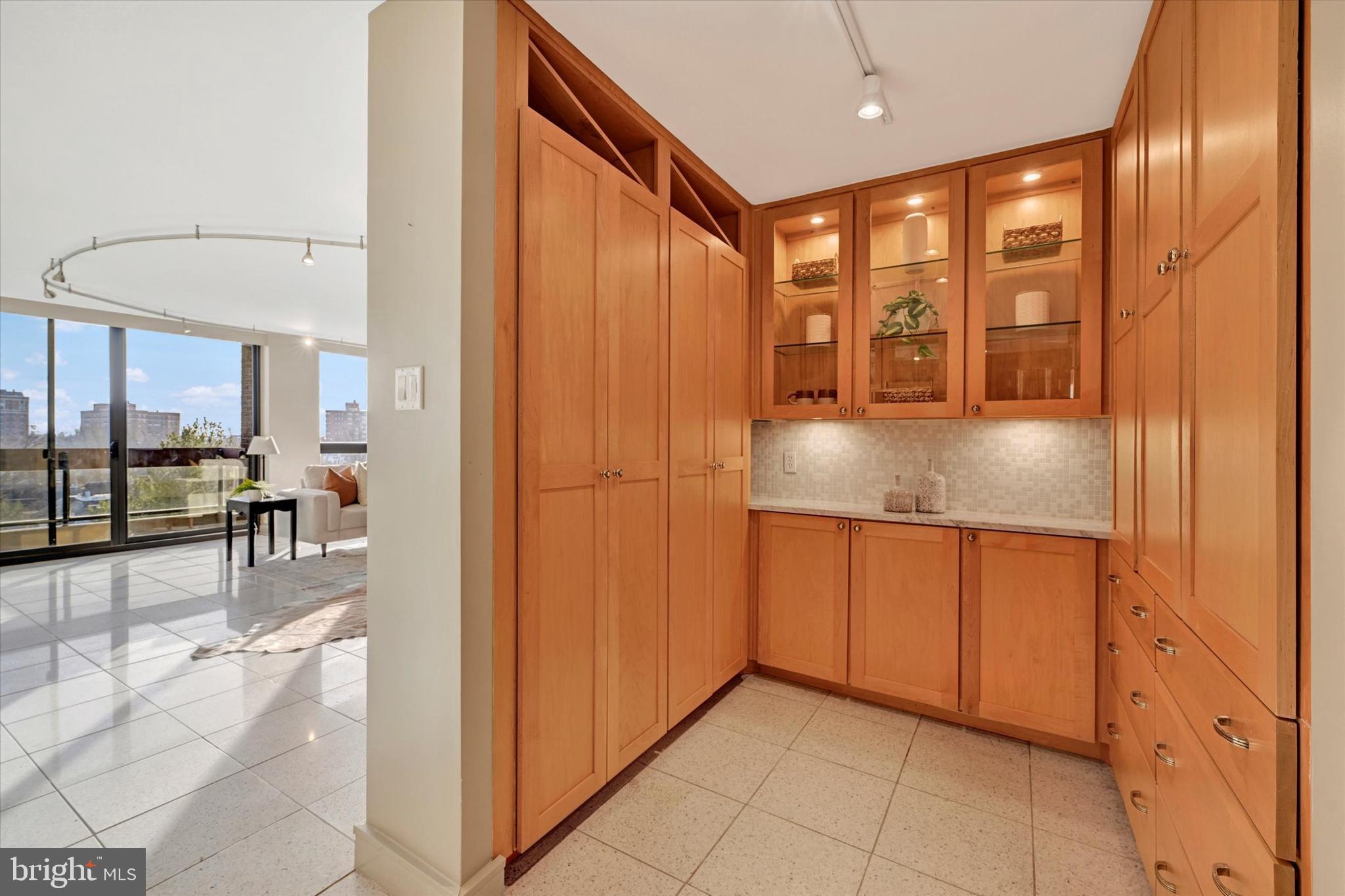 4100 North Charles Street, Unit 609 Baltimore, MD 21218 - Photo 4 of 36 a kitchen with stainless steel appliances granite countertop a refrigerator and a sink
