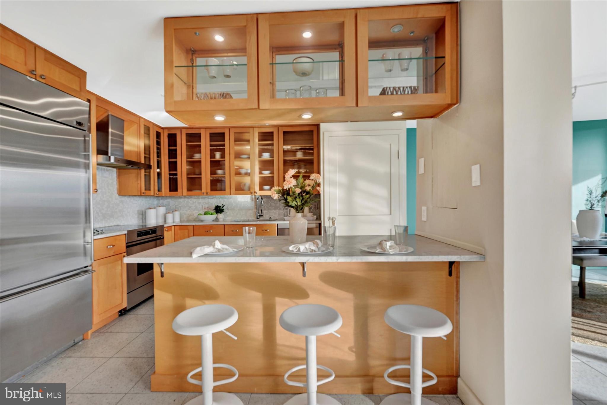 4100 North Charles Street, Unit 609 Baltimore, MD 21218 - Photo 5 of 36 a kitchen with stainless steel appliances granite countertop a sink and a refrigerator