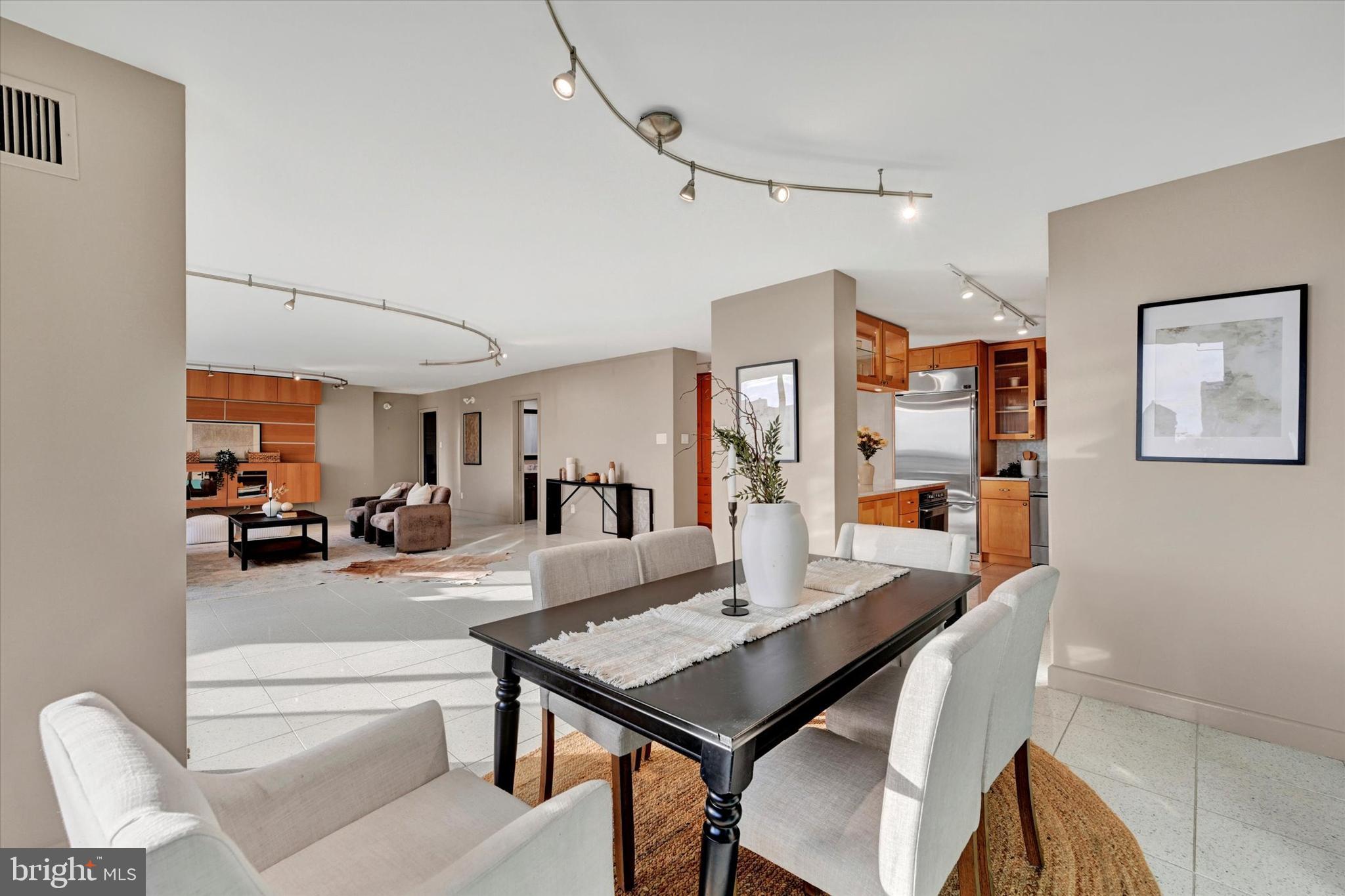 4100 North Charles Street, Unit 609 Baltimore, MD 21218 - Photo 10 of 36 a view of a dining room with furniture and a livingroom