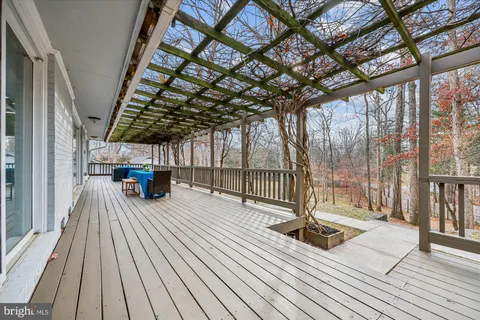 a large kitchen with stainless steel appliances granite countertop a stove top oven a sink dishwasher and a refrigerator