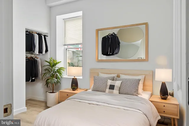 a bedroom with a bed and a potted plant