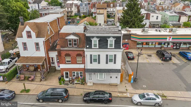 a front view of a building and car parked