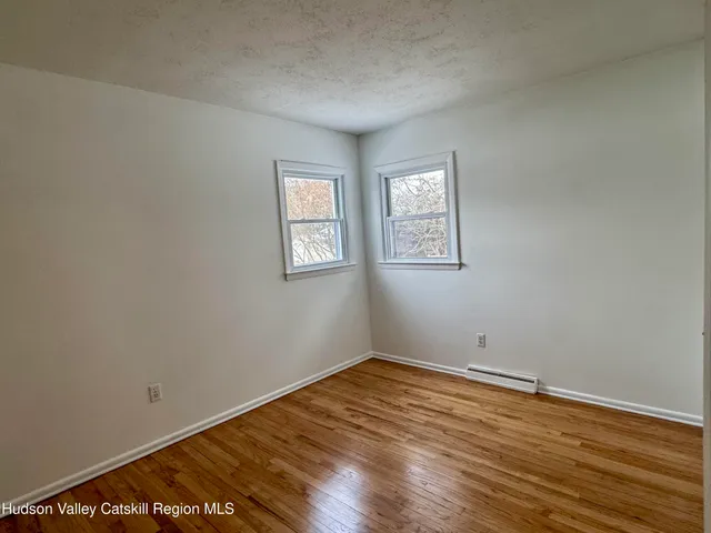 a view of hallway with wooden floor