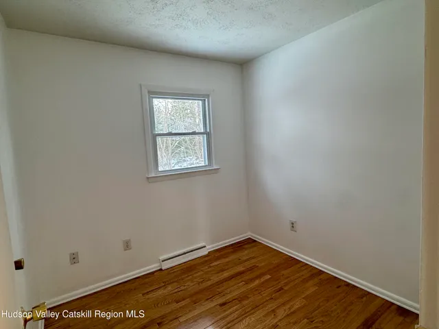 a view of a room with wooden floor and fan
