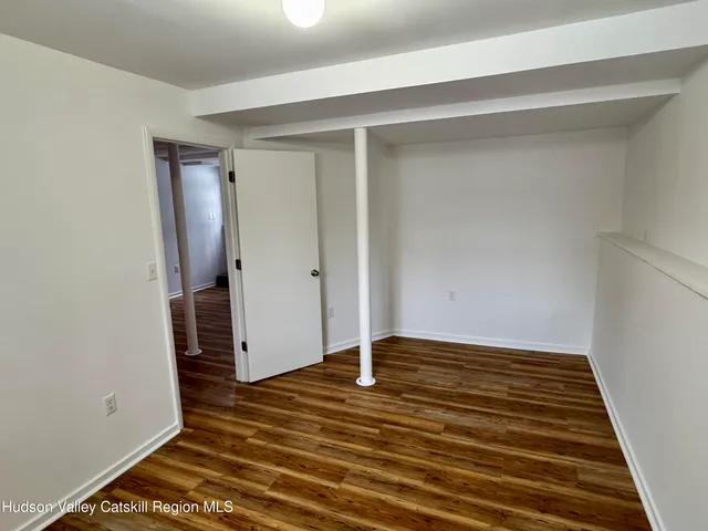 a bathroom with a granite countertop toilet a sink and a window