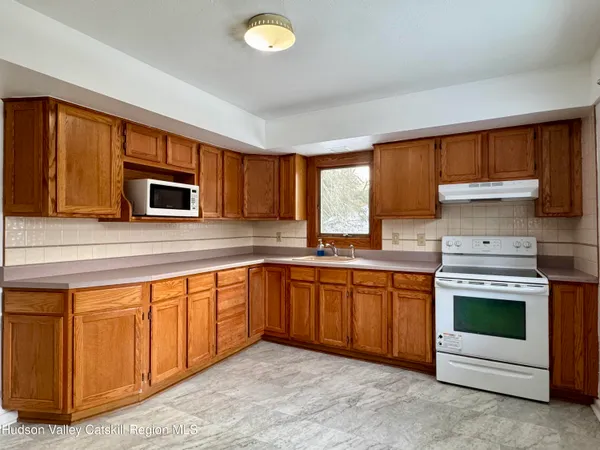 a kitchen with stainless steel appliances granite countertop a stove sink and microwave