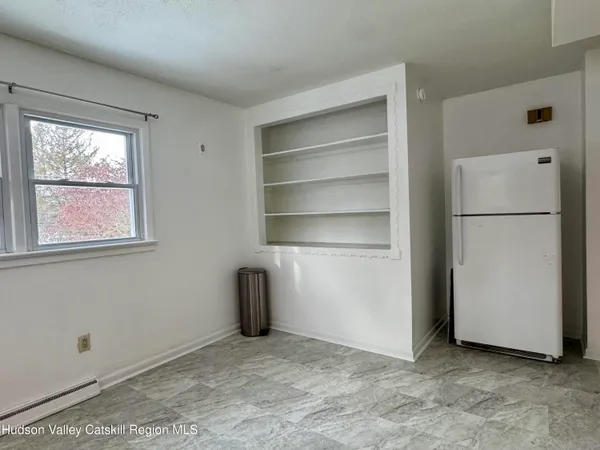 a view of an empty room with a closet
