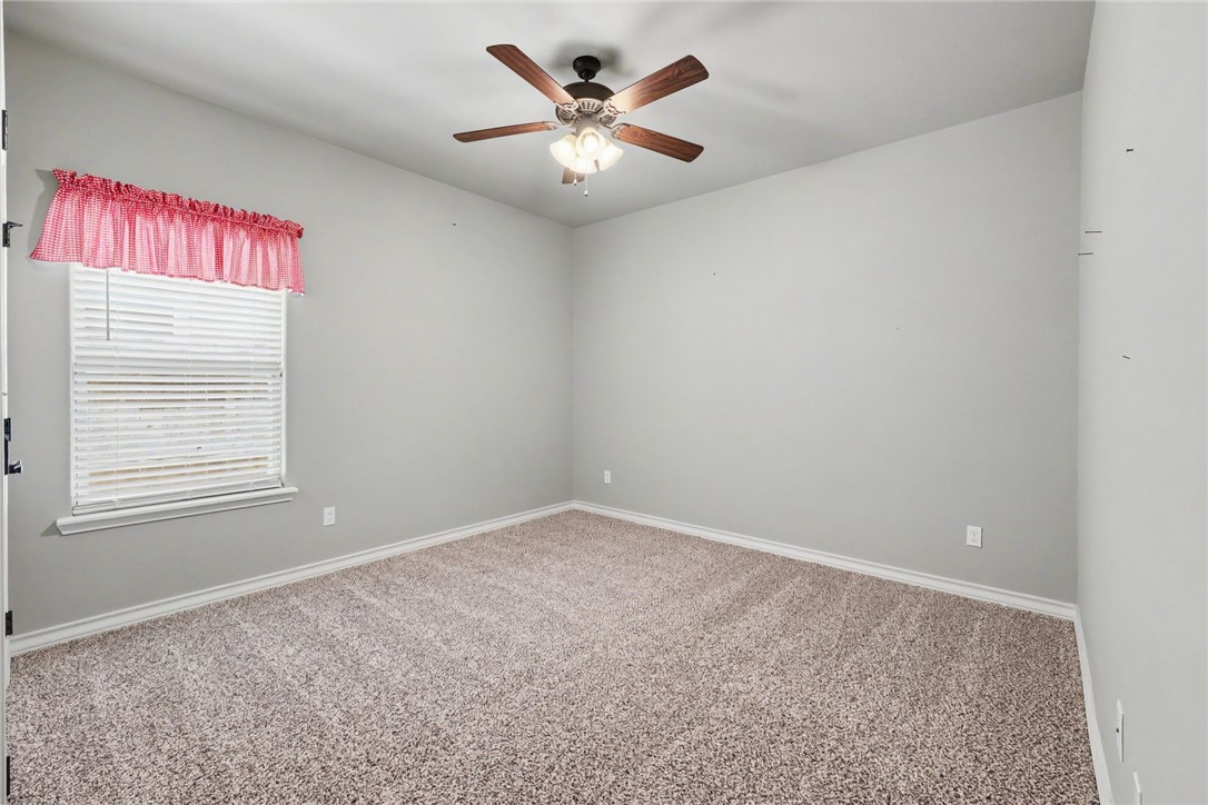 302 Cooper Road, Unit E2 Odem, TX 78370 - Photo 17 of 24 an empty room with windows and ceiling fan