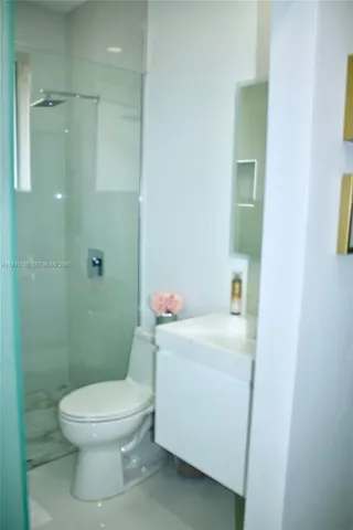 a white toilet sitting next to a bathroom sink