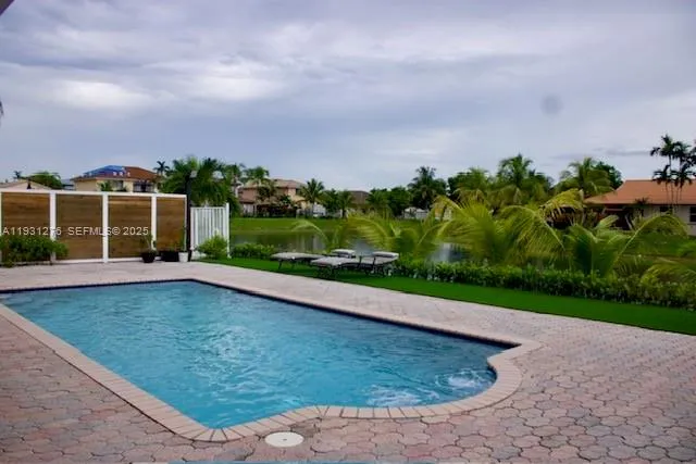a view of a swimming pool with a yard