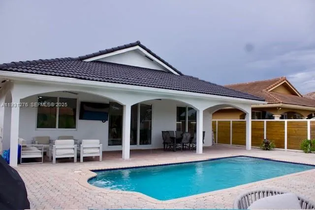 a view of a house with swimming pool and porch
