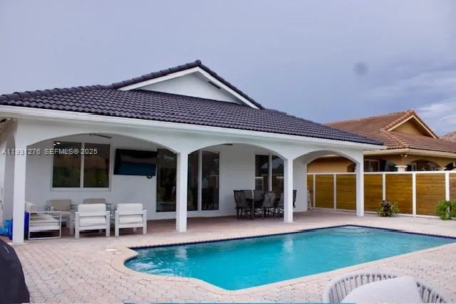 a view of a house with swimming pool and porch