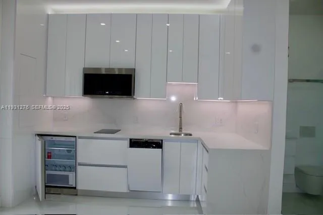 a kitchen with a sink and a stove top oven