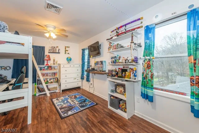 a living room with lots of furniture and a book shelf