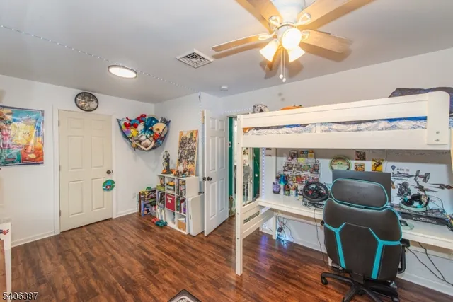 a view of a room with furniture and wooden floor