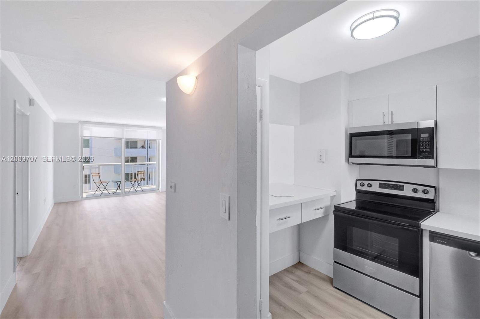 1345 Lincoln Road, Unit 501 Miami Beach, FL 33139 - Photo 12 of 33 a kitchen with a stove and a microwave