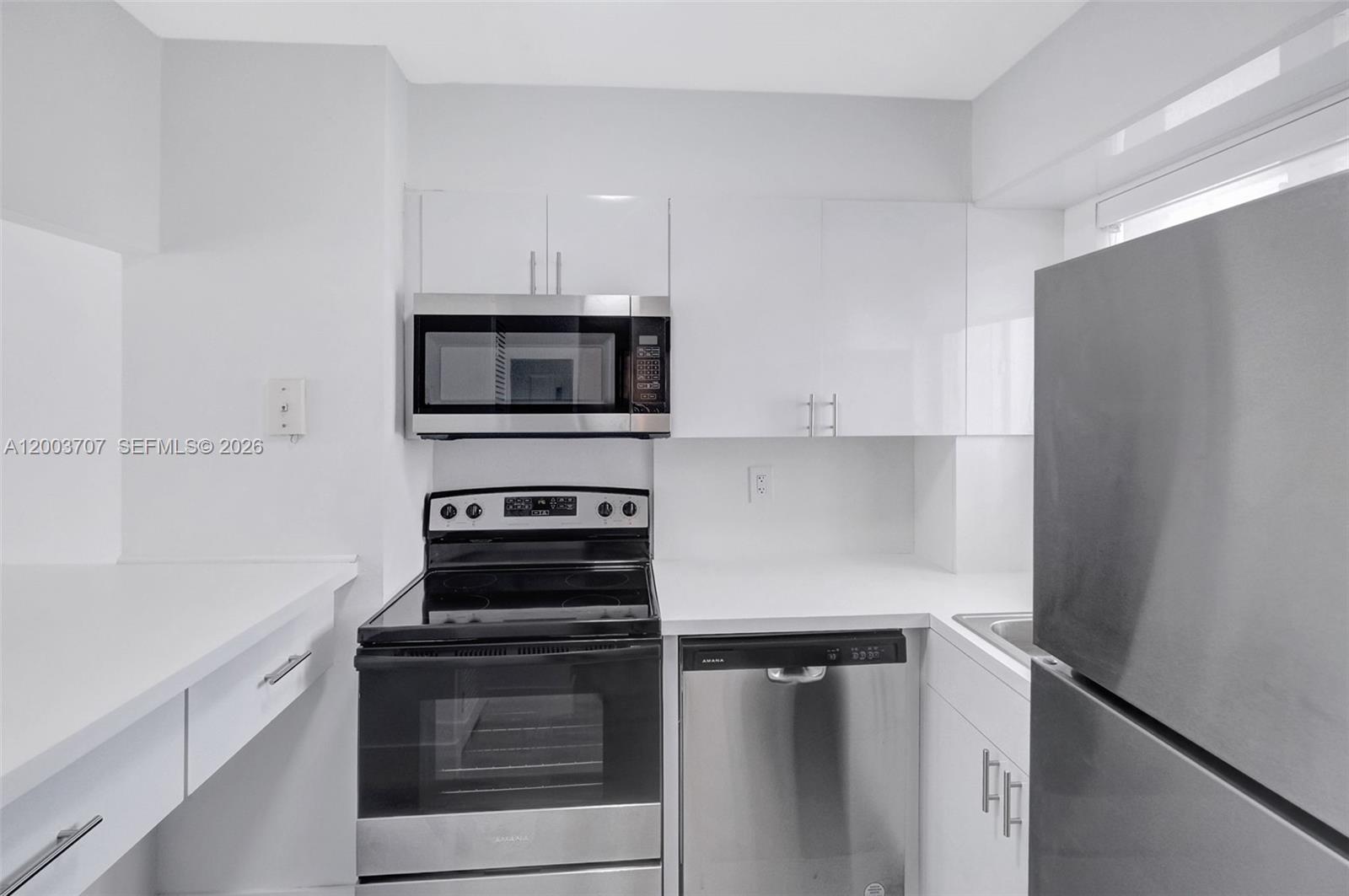 1345 Lincoln Road, Unit 501 Miami Beach, FL 33139 - Photo 13 of 33 a kitchen with cabinets and steel stainless steel appliances